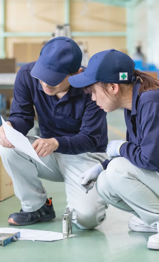 図面を基に打ち合わせを行うスタッフ
